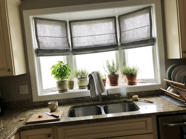 Box bay window with three matching roman shades in an Island Park kitchen