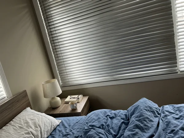 Routless aluminum blind slats closed for privacy in an Ottawa bedroom