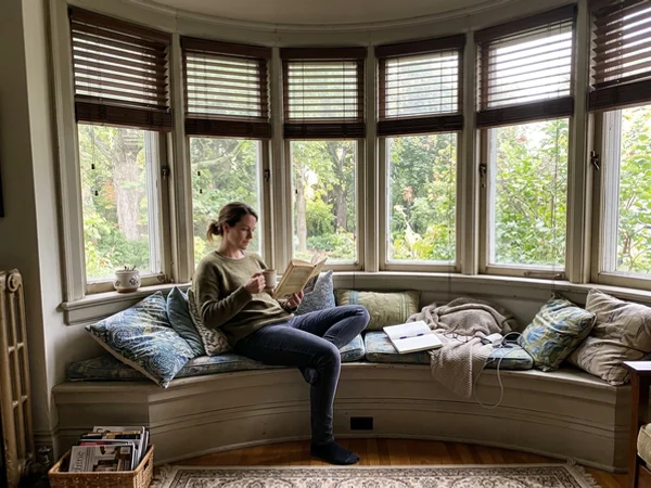 Curved bay window in a Rockcliffe Park home fitted with matching wood blinds