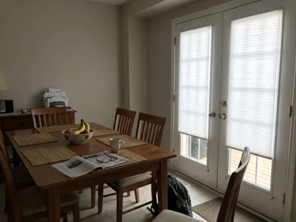 French doors with door-mounted cellular shades and hold-down brackets in Convent Glen