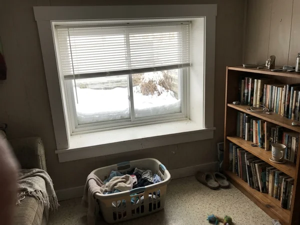 Slim mini blind on a half-height split-level basement window in Gloucester