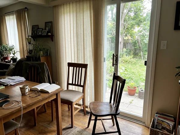 Split-stack fabric vertical blinds parted at the centre of a Bells Corners slider