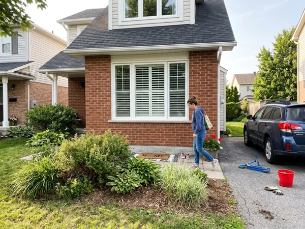 Street view of a Westridge home with white plantation shutters in the front window