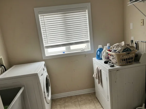 Vinyl blind on a laundry room window in a Barrhaven basement